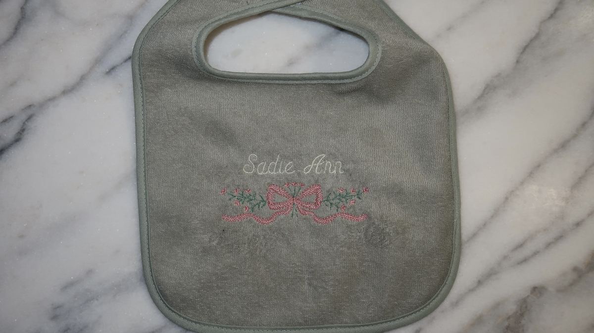 Sage bib — Sadie Ann with floral bow