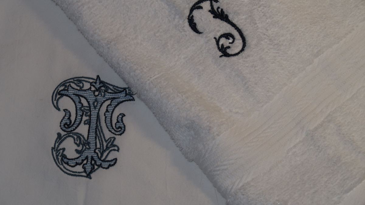 White hand towels with ornate monogram